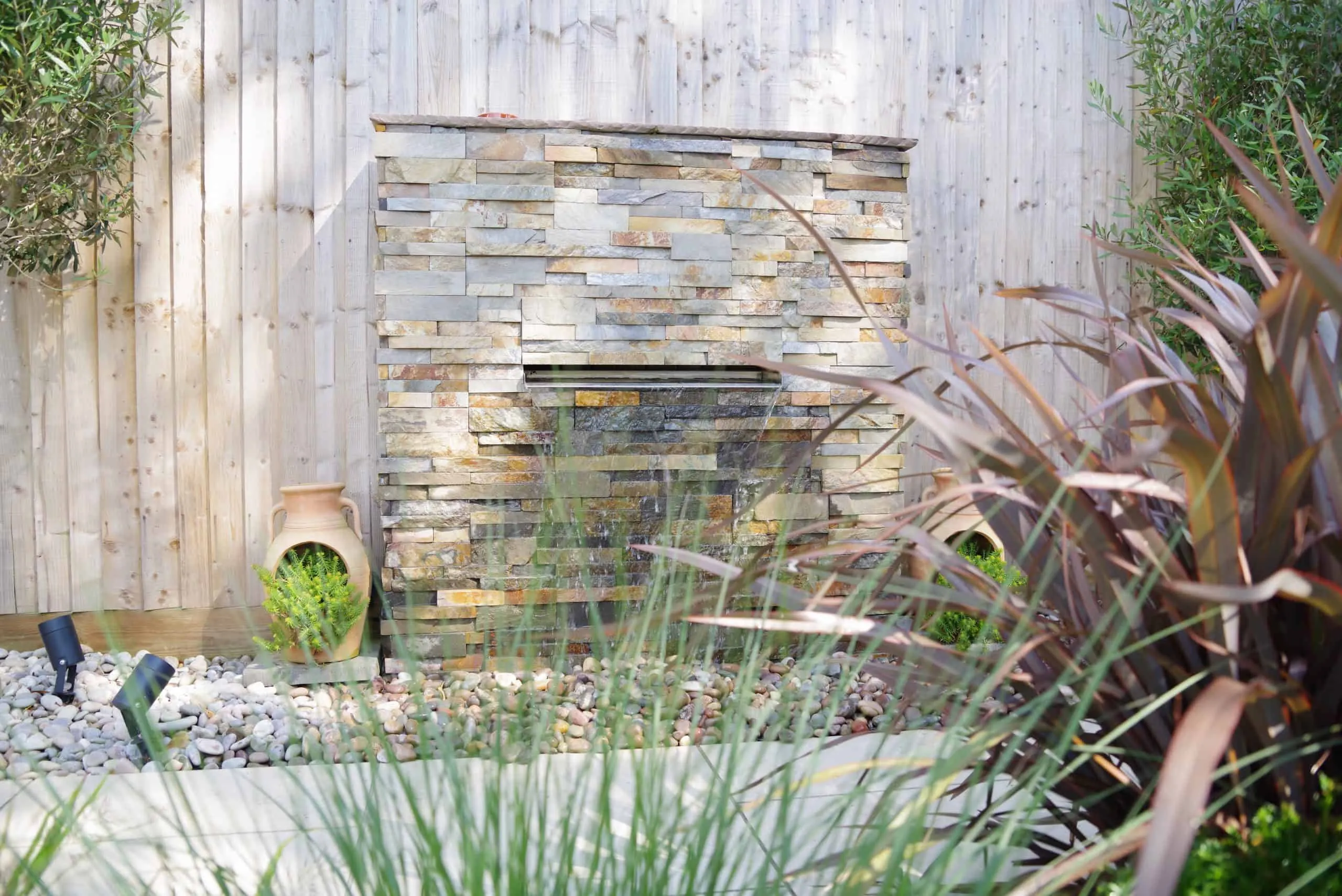 Coastal Garden Ferring A waterfall feature with splitface tile cladding in a new garden in Sussex.