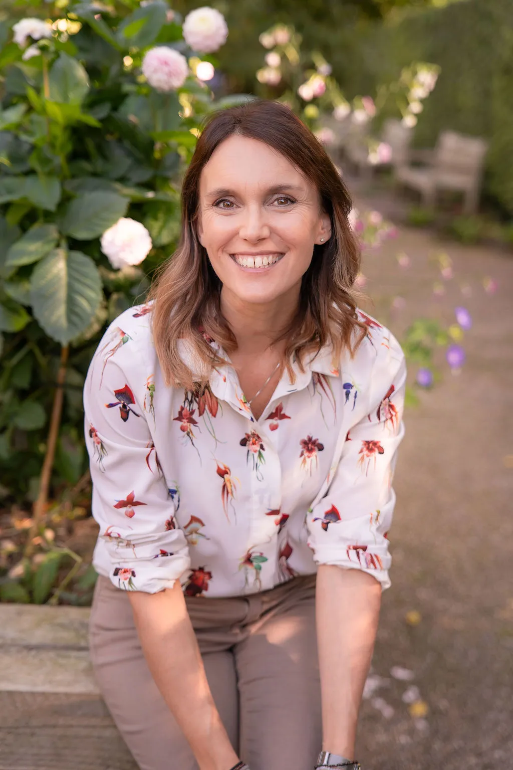 Garden designer Victoria Rumens sitting on a bench
